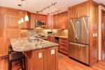 Beautiful kitchen with stainless steel appliances and stone countertops 